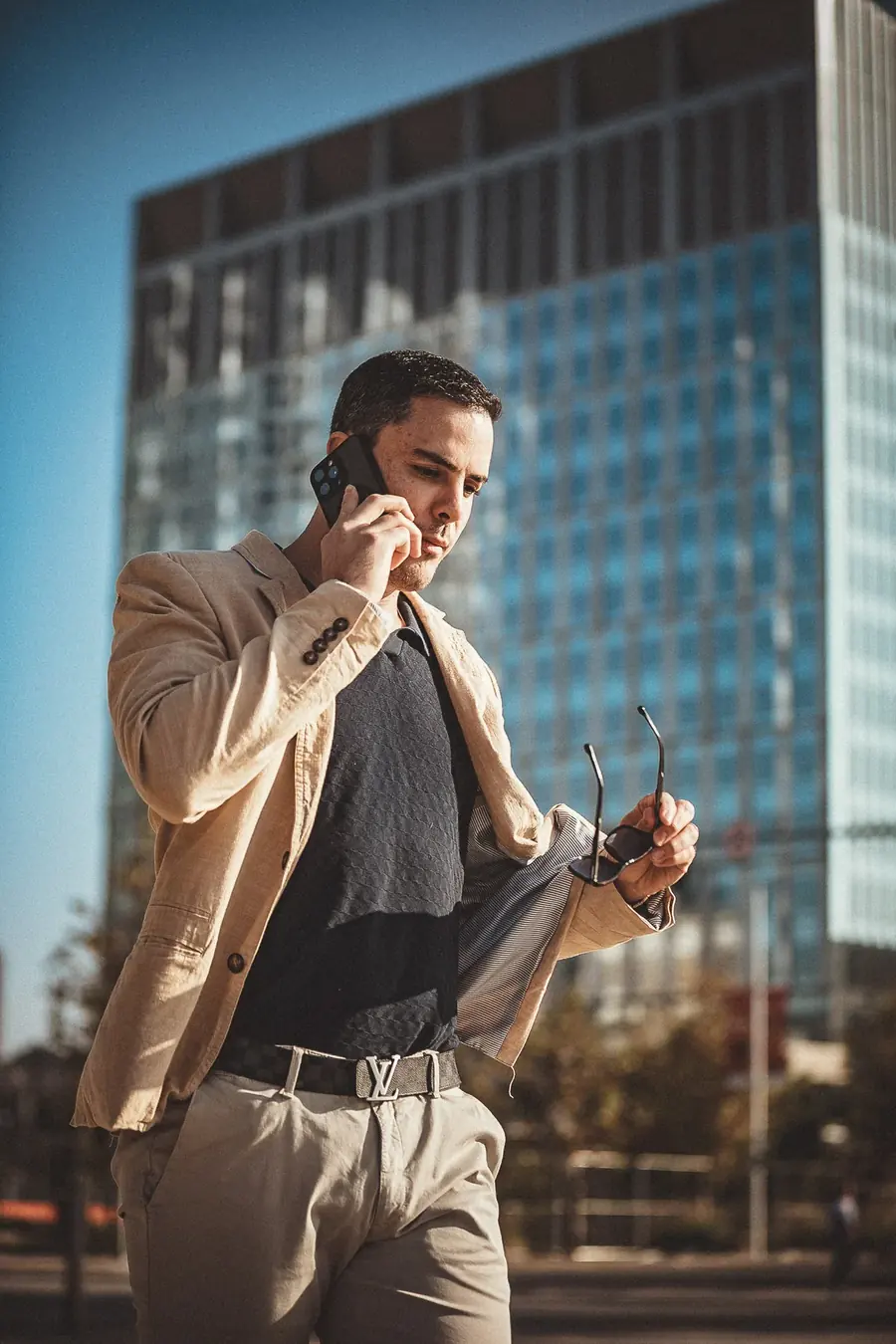 A businessman on a phone call outside an office building